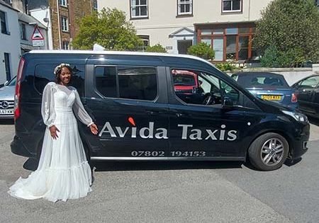 Bride standing in front of Avida taxi